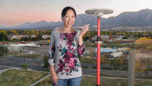 jade morton reseacher standing next to monitoring station